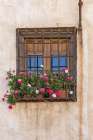 Albaicin, Province of Granada, Andalusia, Spain. Flowers in pots at a barred window. Art Print